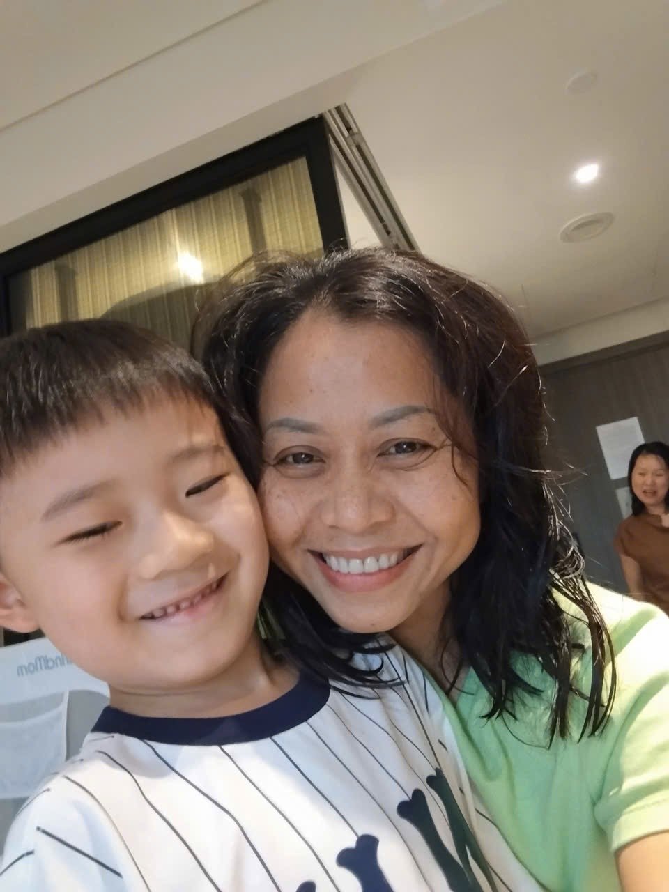 Moon Moon babysitter with a smiling child indoors
